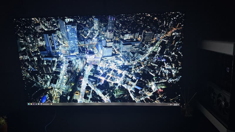 AORUS FO48U showing Tokyo night aerial cityscape angle 1, head-on with Astral RTX 5080 visible at right edge