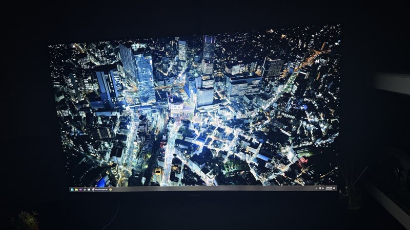 AORUS FO48U showing Tokyo night aerial cityscape angle 3, third position for panel uniformity comparison