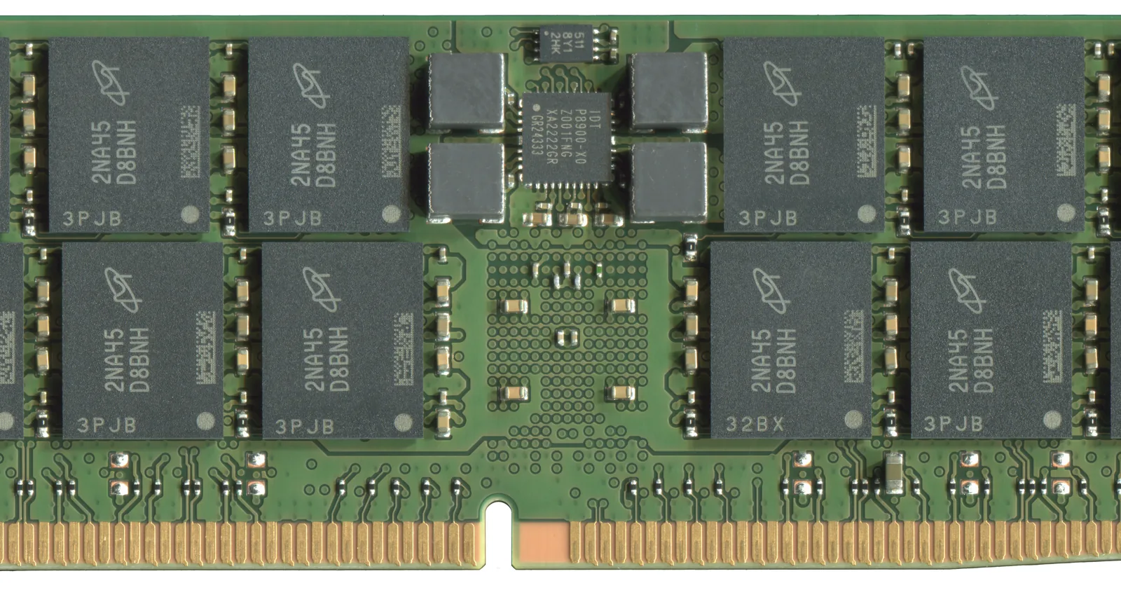 Close-up of the middle of a Micron DDR5 memory module: two rows of black Micron-marked DRAM chips on a green board, the register chip between them