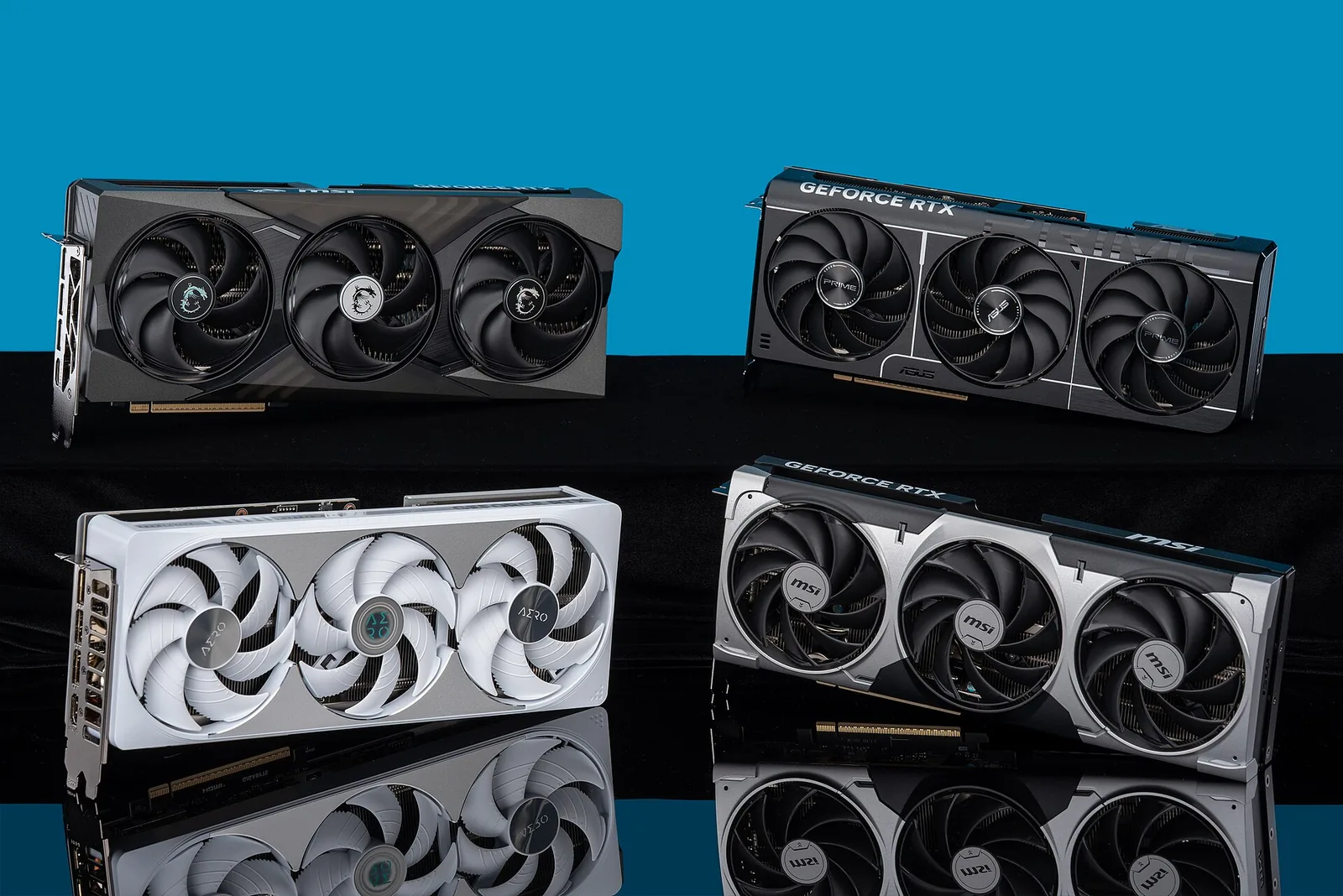 Four GeForce RTX 5080 graphics cards from MSI, ASUS and Gigabyte standing on a black reflective surface against a blue background