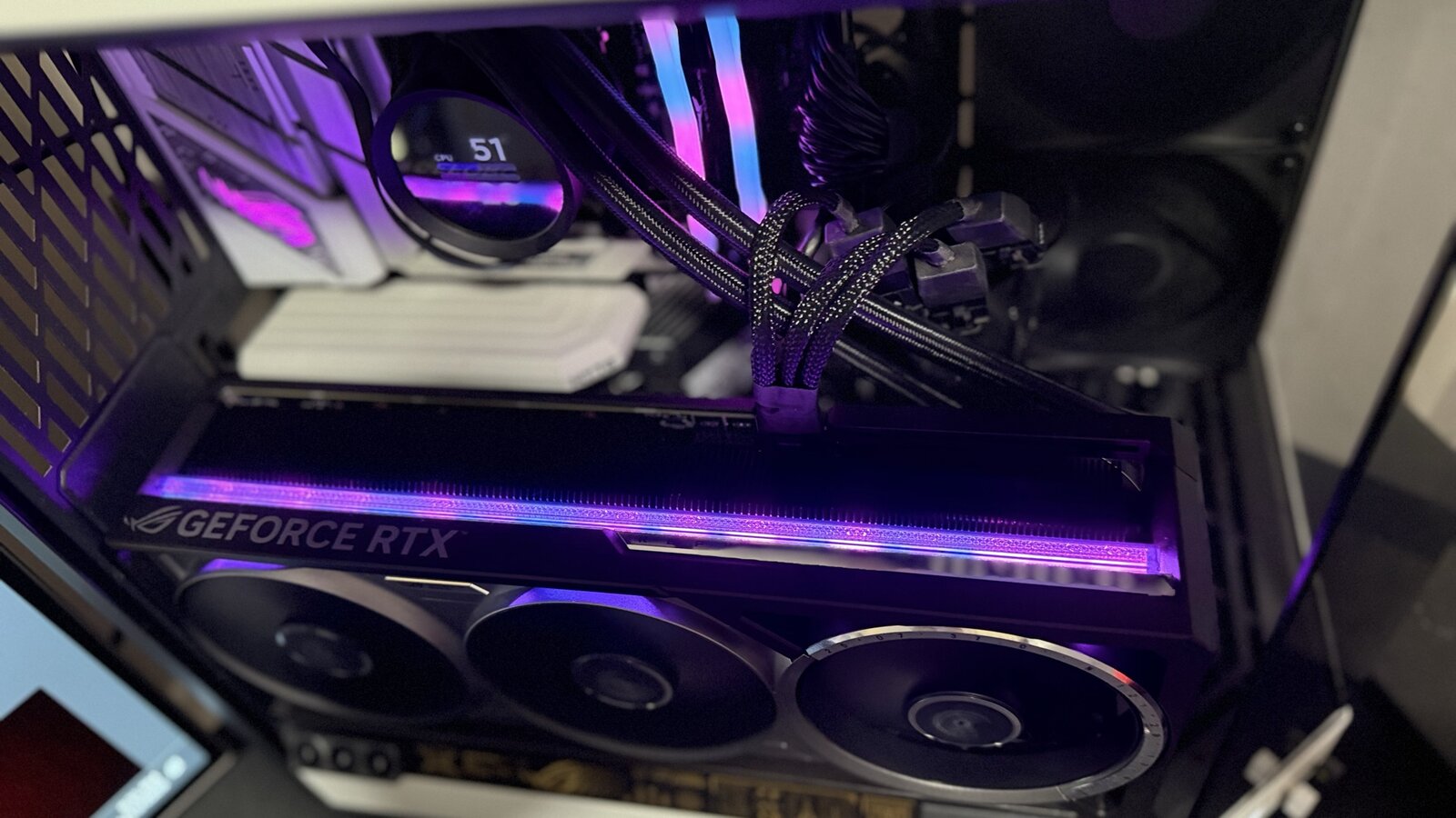 Top-down view of the ROG Astral RTX 5080 showing the illuminated GeForce RTX lettering along the top edge of the card